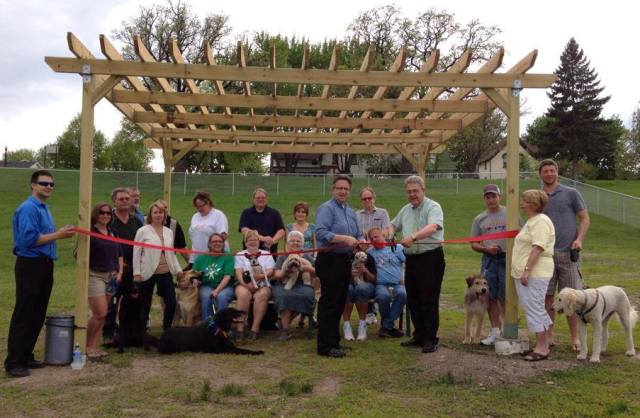 Residents and officials at a ribbon cutting ceremony for the local Dog Park